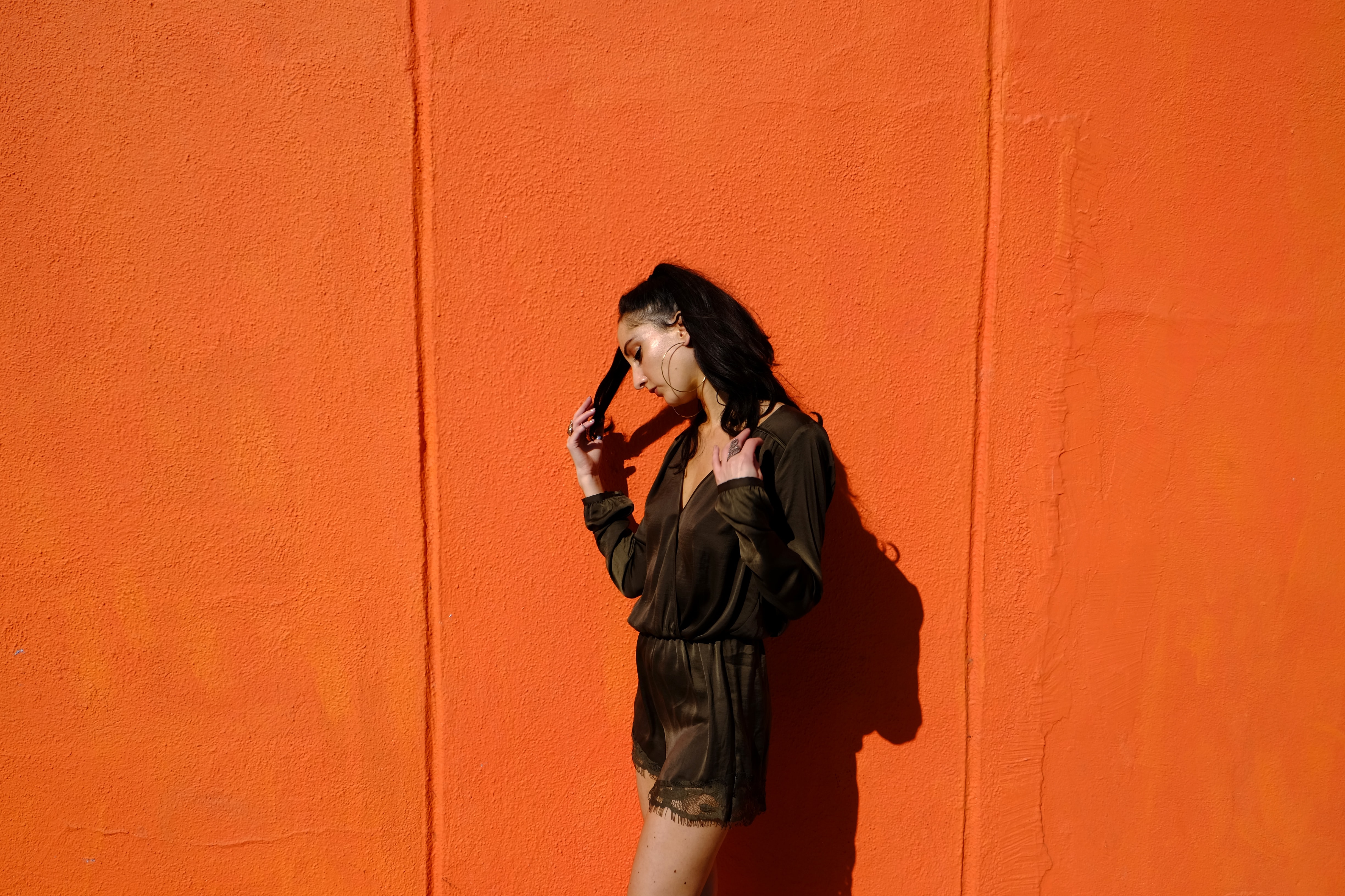 woman near orange wall