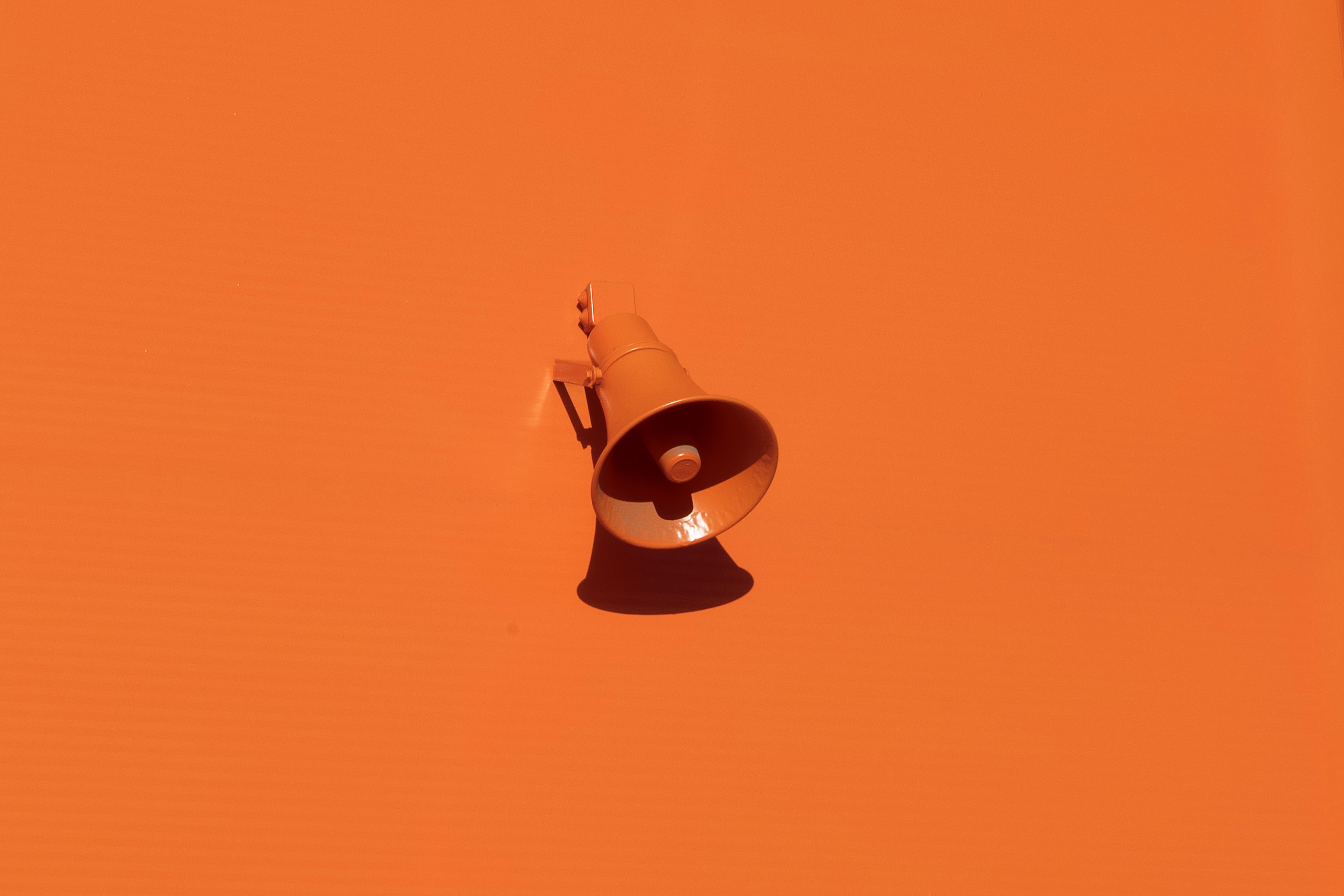 orange megaphone on orange wall